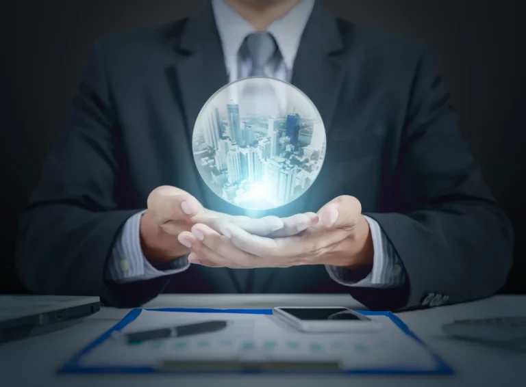 Businessman in suit holding glowing crystal ball with cityscape inside.