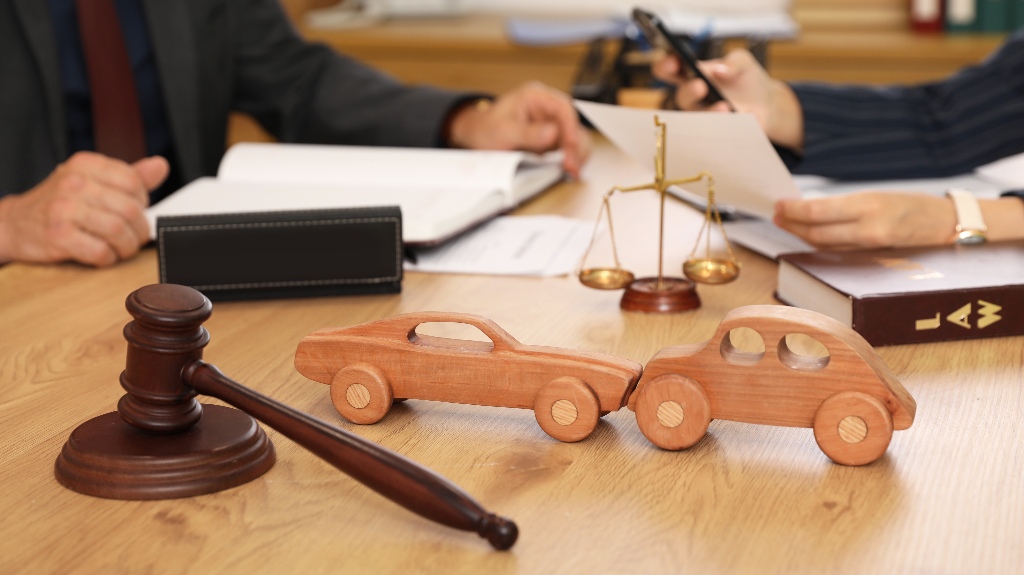 Wooden cars with judge's gavel on lawyer's table