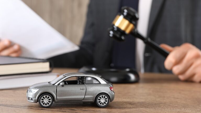 Man with document and gavel with toy car