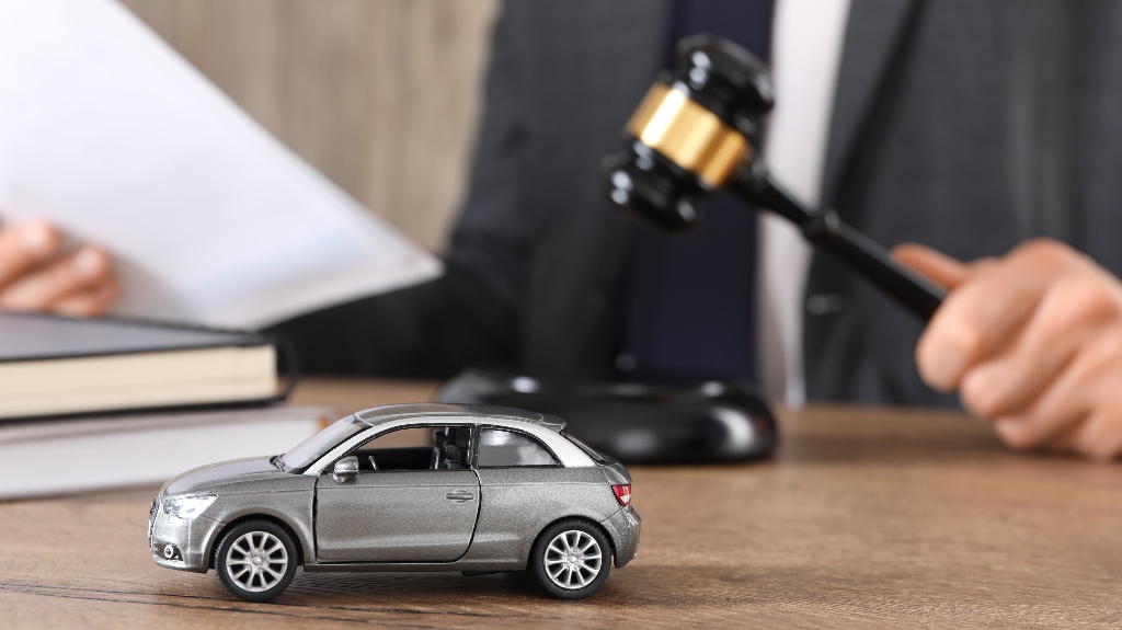 Man with document and gavel with toy car