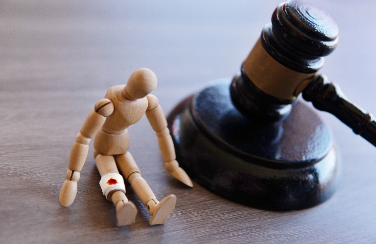 Bandage wrap with blood stain, wooden doll and judge gavel