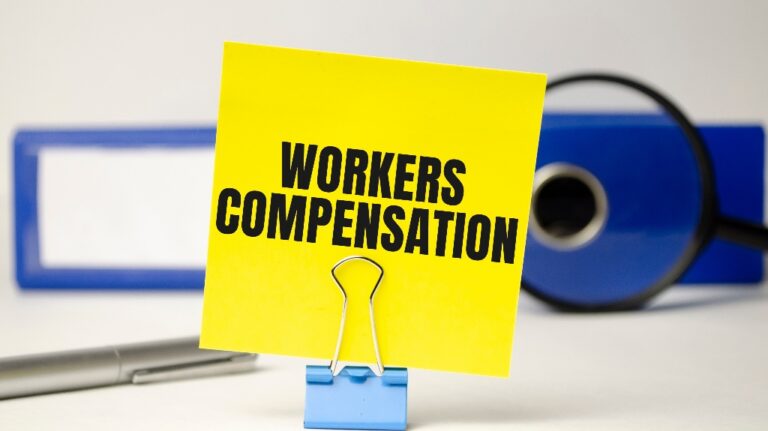 Workers compensation on yellow sticker and blue file folder