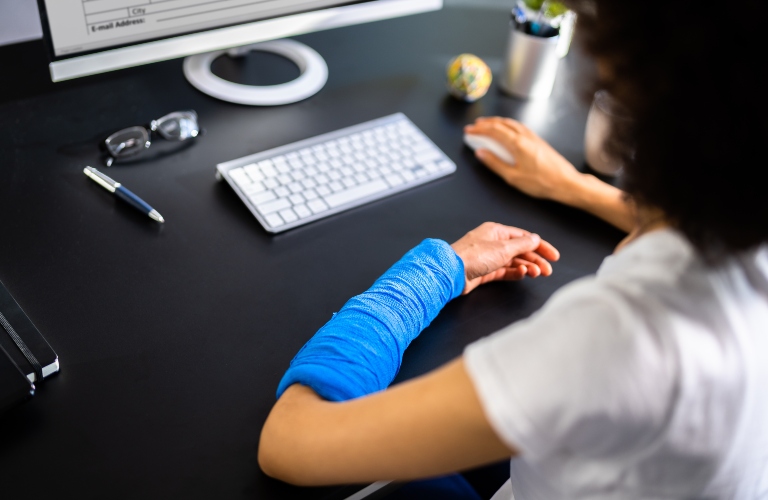 Injured Worker Compensation. Broken Arm African Woman On Computer_s Neck At Workplace