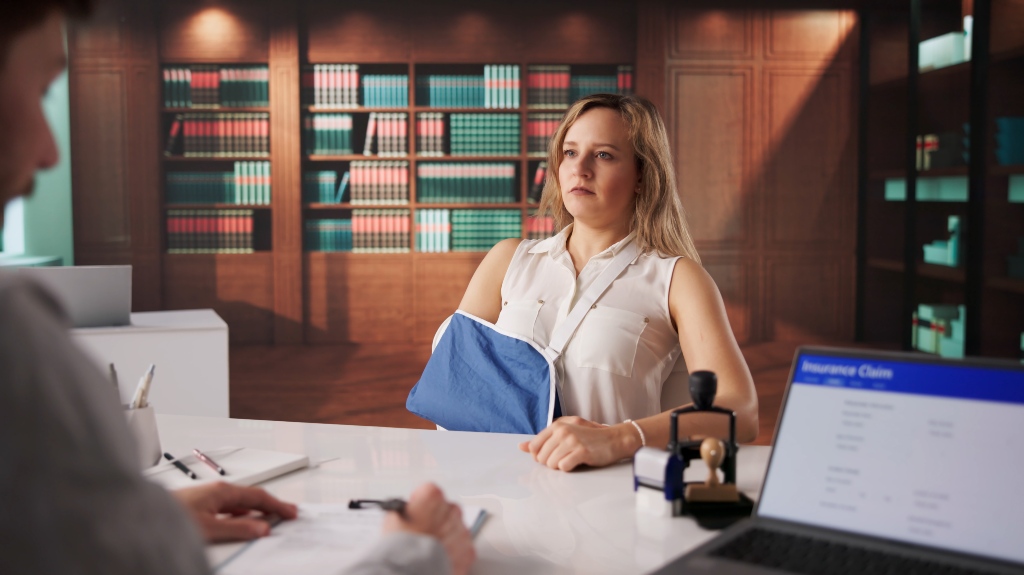 Injured Worker Consulting Attorney Over Compensation Claim Papers At Workplace